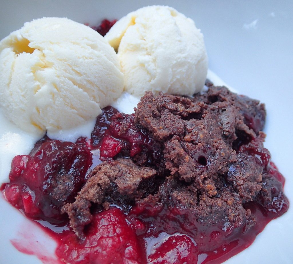 Dark Chocolate Raspberry Cobbler in a Dutch Oven - Gourmet camping is totally doable with this simple recipe. From dirtydishclub.com